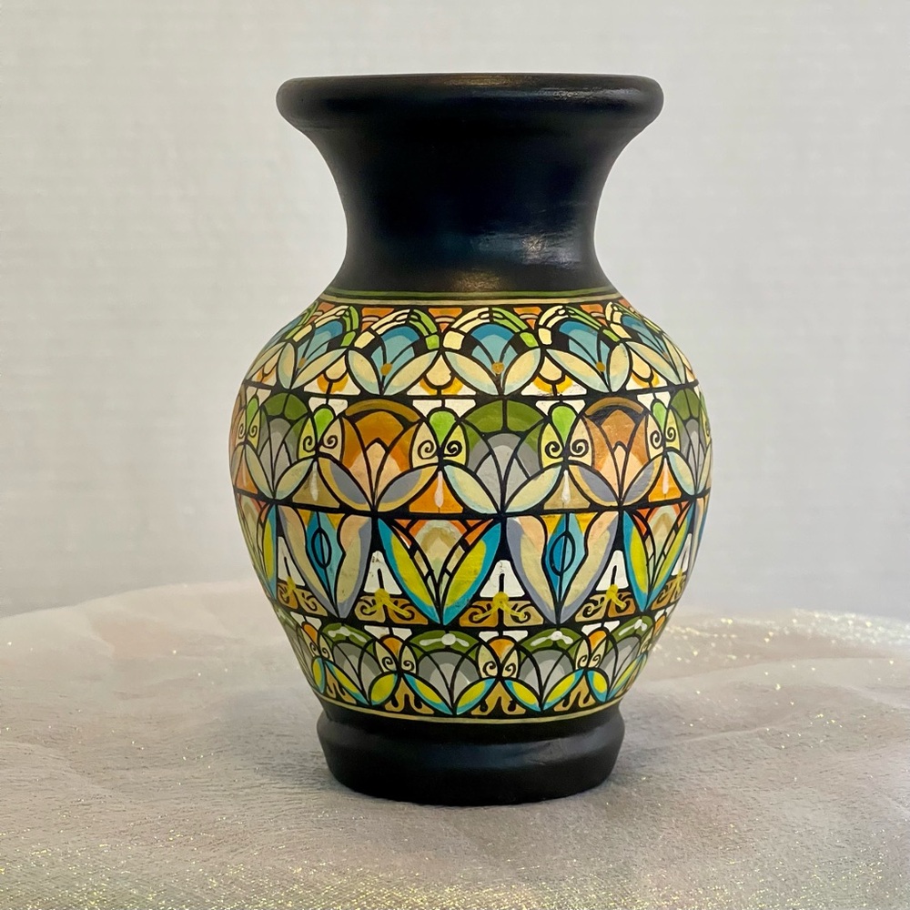 Antique handcrafted ceramic vase. Features an intricately hand-painted pattern.
